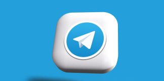 a blue and white square button with a paper airplane on it