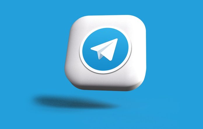 Photo by Rubaitul Azad a blue and white square button with a paper airplane on it