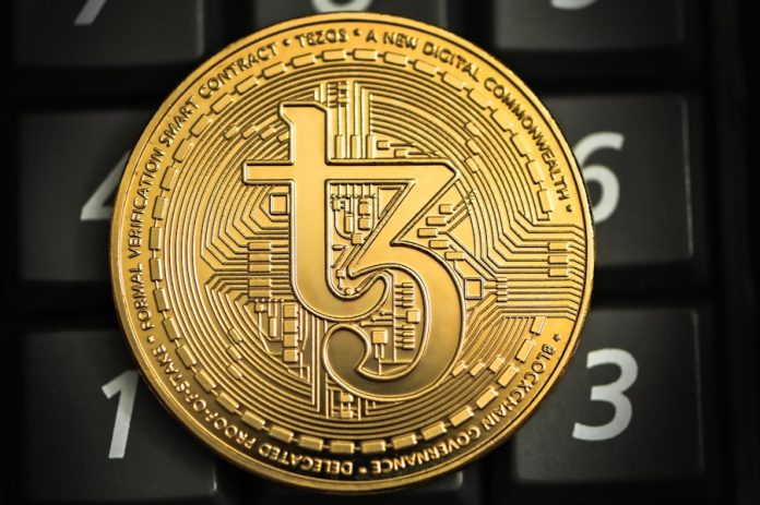 Photo by Traxer a gold coin sitting on top of a computer keyboard
