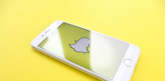 silver iPhone 6 on top of yellow wooden surface
