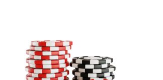 a stack of poker chips with a heart on top