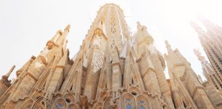 Low angle view of the iconic Sagrada Familia, revealing its intricate architecture in Barcelona, Spain.