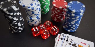 A vibrant display of casino chips, dice, and playing cards set on a table, embodying chance and excitement.