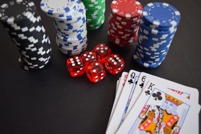 Photo by Pixabay A vibrant display of casino chips, dice, and playing cards set on a table, embodying chance and excitement.