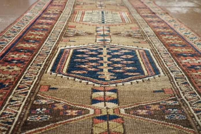Photo by Robert Sciberras a large oriental rug on a wooden floor
