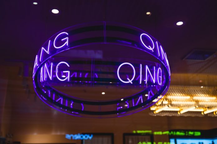 Photo by J F a neon sign hanging from the ceiling of a building