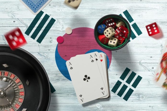 South Korea casino theme. Aces in poker game, cards and chips on red table with national flag background. Gambling and betting.