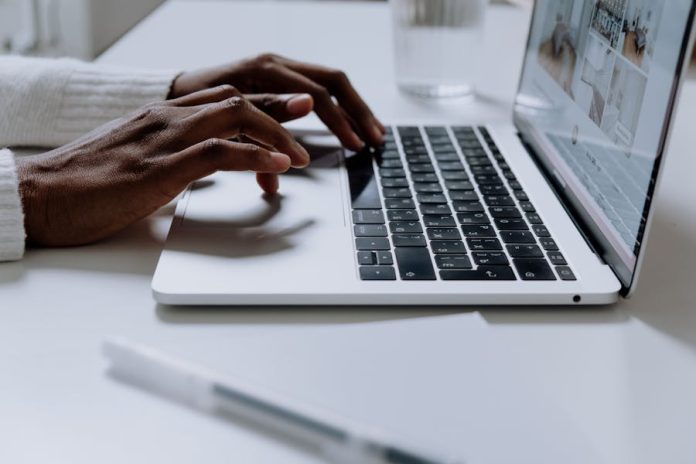 Photo by cottonbro studio Hands typing on a sleek laptop keyboard, illustrating modern technology in use.