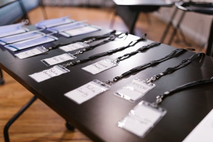 Photo by RDNE Stock project Close-up of name tags and folders laid out for a conference or meeting.