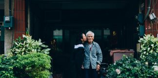 woman kissing man standing
