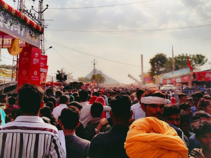 Photo by Himanshu Kiradiya A crowd of people standing around a stage