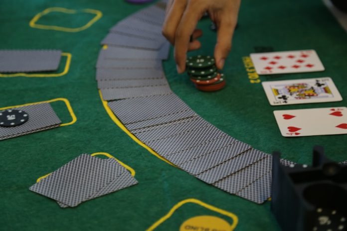 Photo by An Lê Khánh a person playing a game of cards on a table