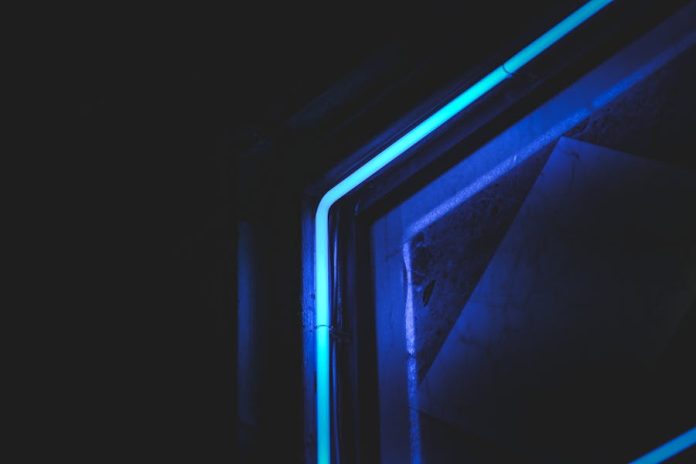 Photo by Francesco Ungaro Abstract close-up of neon blue light in dark setting, highlighting modern artistic design.