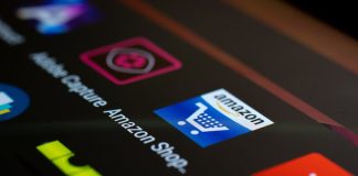Close-up of the Amazon shopping app icon on a smartphone screen. Ideal for online shopping and technology themes.