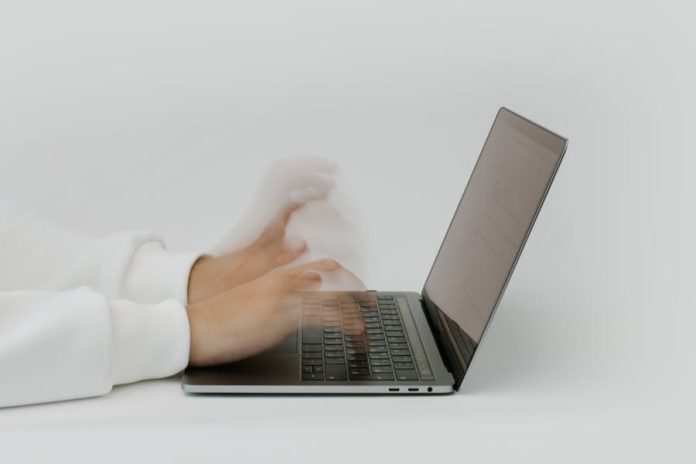 Photo by cottonbro studio Hands rapidly typing on a laptop, illustrating speed and technology in a digital work environment.