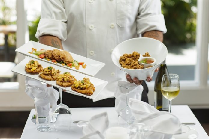 Photo by The Storyteller Agency.co person in white dress shirt holding white ceramic bowl with food