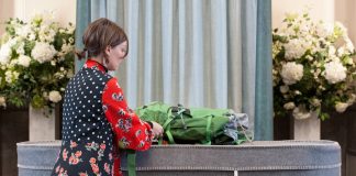 a woman standing in front of a suitcase