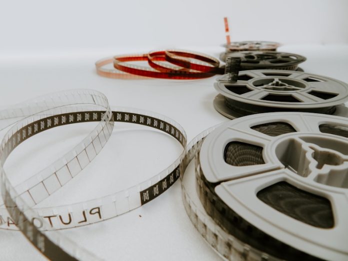 Photo by Denise Jans four reel films lying on white table