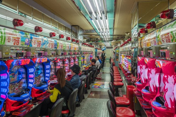 Photo by Alexander Schimmeck people sitting on red plastic chairs inside building