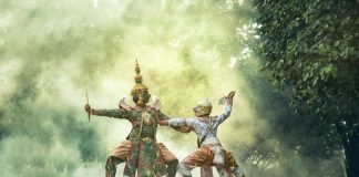 Cultural Asian performance featuring two dancers in elaborate costumes in a misty, outdoor setting.