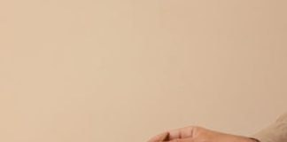 Premium Kratom Vendors in 2025: Expert Analysis and Reviews A hand carefully adding matcha powder to a ceramic cup positioned on a wooden table.