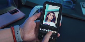 a person holding a cell phone with a picture of a woman on the screen