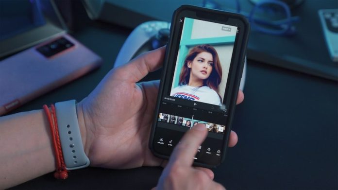 Photo by Onur Binay a person holding a cell phone with a picture of a woman on the screen