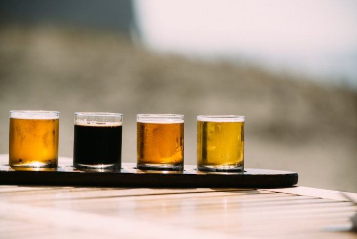 Photo by Blake Wisz a group of glasses with liquid in them