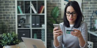 Fintech for Global Creators: How LinkPay Cards Power Cross-Border Payments a woman sitting at a table looking at her cell phone