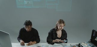 Working Capital: Short-Term Loan vs. Line of Credit Two people counting money at a desk with computers and cash equipment.