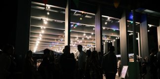 a group of people standing in a room with lights
