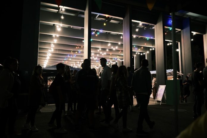 a group of people standing in a room with lights