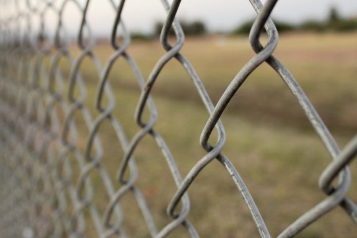 Photo by Matt CL a close-up of a barbed wire fence