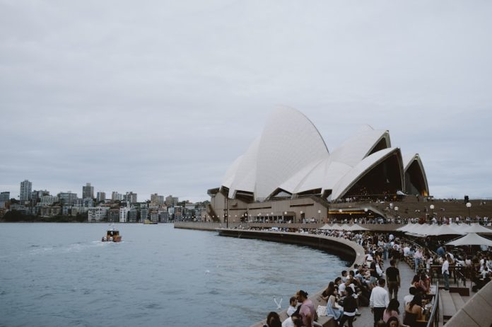 Photo by Nguyen Minh The sydney opera house stands by the water.