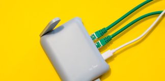 Managed Wi-Fi and Cloud Management: Simplifying Network Operations Router with cables plugged in, on yellow background.
