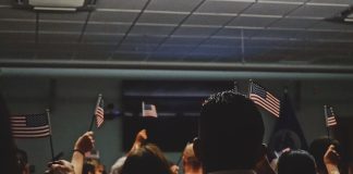 people holding flag of U.S.A miniature