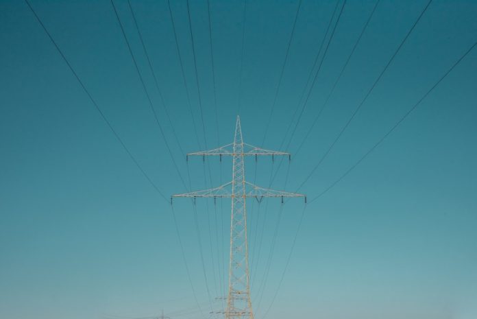Photo by Sven Mieke white electric post under blue sky during daytime