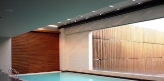 Why Homeowners Are Choosing Indoor Pools two gray sofas beside pool in room