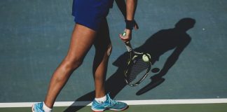 How to Choose the Right Tennis Racket for Your Skill Level from the Best Tennis Shop in Dubai woman holding tennis ball and racket