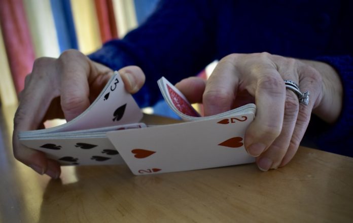 a person is playing cards on a table