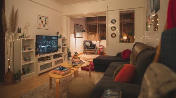 Photo by Joao Macedo a living room filled with furniture and a flat screen tv
