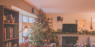 Warm and inviting living room with a Christmas tree, fireplace, and holiday decor, perfect for the winter season.