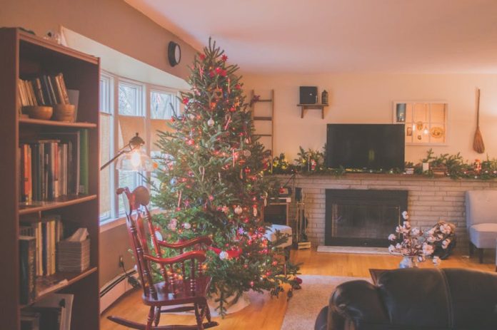 Photo by Jessica Lewis 🦋 thepaintedsquare Warm and inviting living room with a Christmas tree, fireplace, and holiday decor, perfect for the winter season.