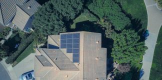 Smooth & Easy Home Generator Installation to Power Your Home Always Top-down aerial view of a house with solar panels, showcasing modern renewable energy solutions.