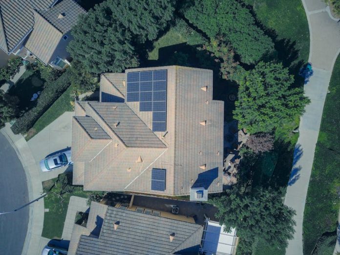 Photo by Kindel Media Top-down aerial view of a house with solar panels, showcasing modern renewable energy solutions.