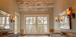 comfort room with white bathtub and brown wooden cabinets