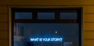 black flat screen tv turned on at the living room