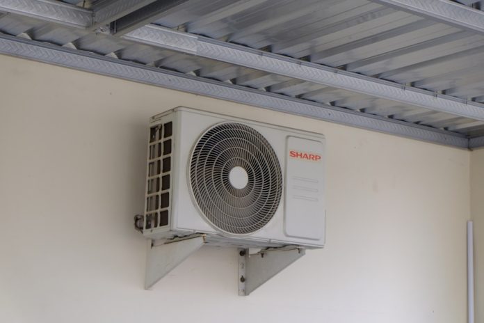 Photo by Andrianto Cahyono Putro An air conditioning unit mounted on a wall.