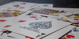 Discover the Relaxation Benefits of Spades Card Game A pile of playing cards sitting on top of a table