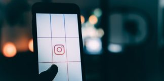 person using smartphone with Instagram logo screengrab bokeh photography